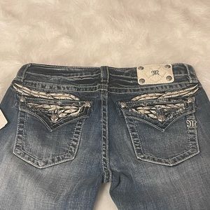 NEW MISS ME mid-rise skinny jeans.